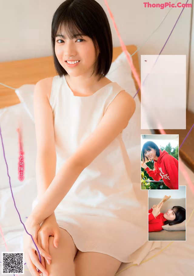 A woman in a white dress sitting on a bed.