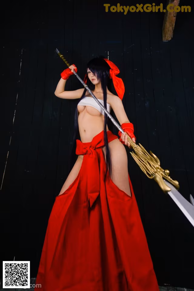 A woman in a red dress holding a sword.